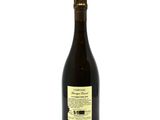 a bottle of wine sitting on top of a white table