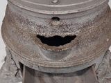 an old metal pot with a mustache on top of it