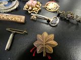 many different types of brooches on a table