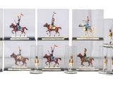 a lot of miniature figurines of people riding horses