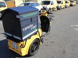 many yellow and black vehicles parked in a parking lot