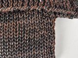 a close up of a brown knitted sweater with a long sleeve