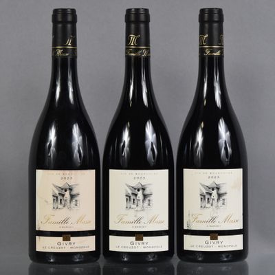 three bottles of wine are lined up on a table