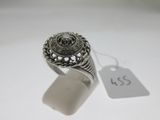 a close up of a silver ring with a tag on it