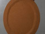 a person holding a brown plate in their hand