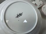 a white plate with black writing on it sitting on a table