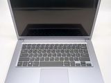 a silver laptop computer sitting on a white surface