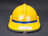 a close up of a yellow hard hat on a black background