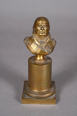 bronze bust of a man on a pedestal with a chain around his neck