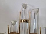 a bunch of glass candles that are sitting on a shelf