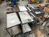 several tables and carts in a warehouse with boxes