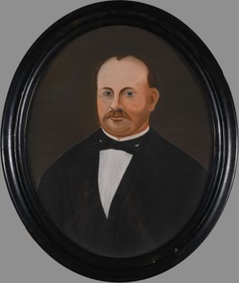 portrait of a man in a tuxedo in a black frame