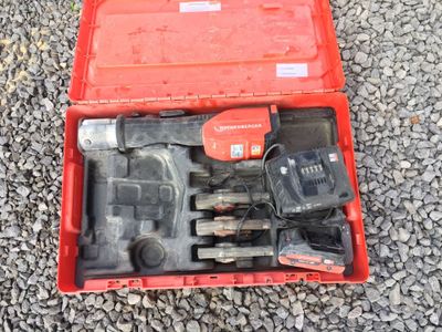a red box with tools in it sitting on the ground