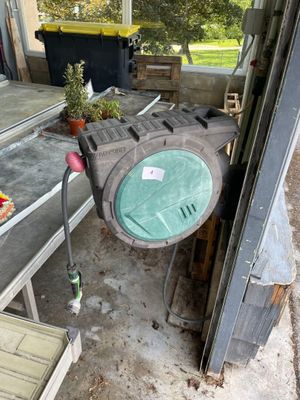 a table that has a clock on it in the middle of a yard