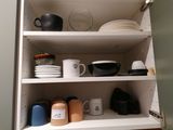 a cabinet with a lot of dishes and cups on it