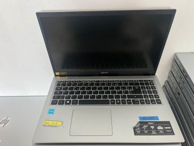 an open laptop computer sitting on top of a desk next to a stack of books