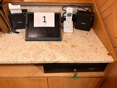 a picture of a counter top with a laptop and other electronics on it