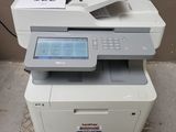 a white printer sitting on top of a table next to a brown wall