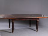 an old wooden table with a marble top and two legs