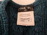 chanel label on a blue sweater on a white background