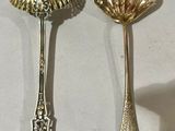 two spoons that are sitting on a table