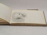 an open book with a drawing of a bird on it