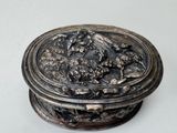 a silver box with a picture of a bird on it