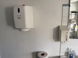 a bathroom with a toilet, sink, and mirror in it