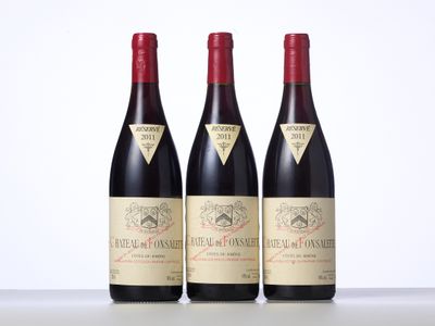 trois bouteilles de vin rouge sont alignées sur une table
