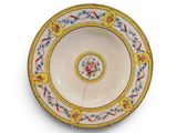 a plate with a floral design on it on a white surface