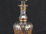 an image of a clear glass bottle with a gold design on it