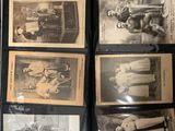 a lot of old black and white photos on a shelf