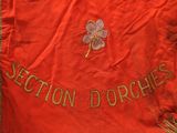 an old red jacket with a four leaf clover on it