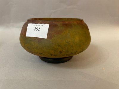 a brown bowl with a tag on it sitting on a table