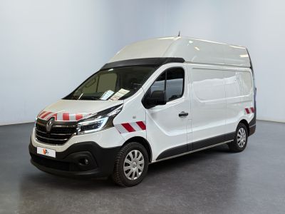 the white van is parked in a large room with a red and white stripe on the side of the van