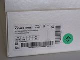 a white box with a green sticker on it