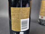 a bottle of wine sitting next to a bottle of wine