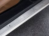 a close up of a car door with a brown bag in it