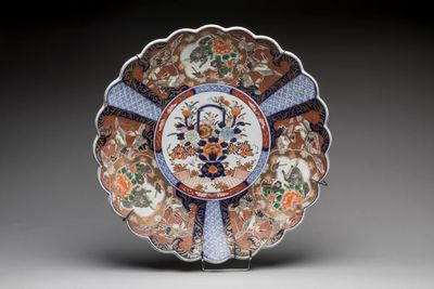 an orange, blue and white plate with a floral design on it