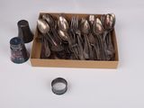 a box full of silverware and a bottle of ink
