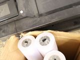 three rolls of toilet paper in a box on the floor