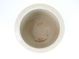 a close up of a white cup on a table