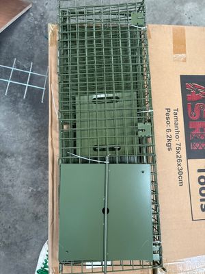 a box with a cage on top of it on the floor
