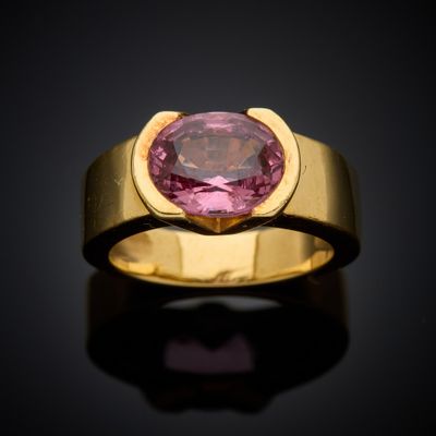 a gold ring with a pink tourmaline stone in the center