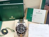 a rolex watch in a box on a table
