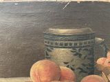 a painting of peaches and a basket of strawberries on a table