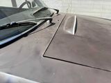 a close up of a car ' s hood and windshield
