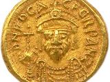 une pièce d'or à l'effigie d'un homme coiffé d'un chapeau