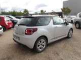 a small silver car parked in a lot with other cars