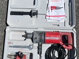 a box with a hammer, drill, and other tools in it